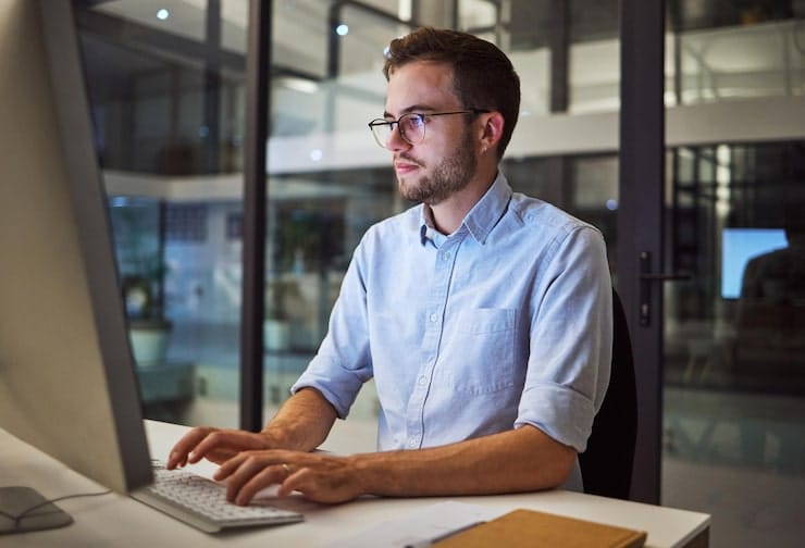 A professional working on JS CODE OUTPUT in an office